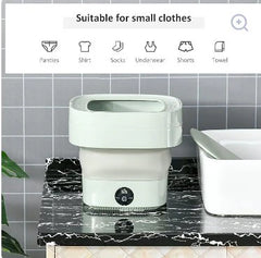 White laundry basket on a marble surface with small clothes icons above.
