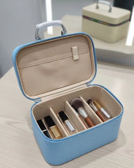Blue makeup case with brushes on a light surface
