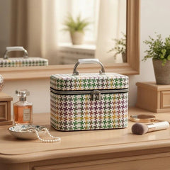 Multicolored patterned makeup case on a wooden dresser with a mirror and decorative items.